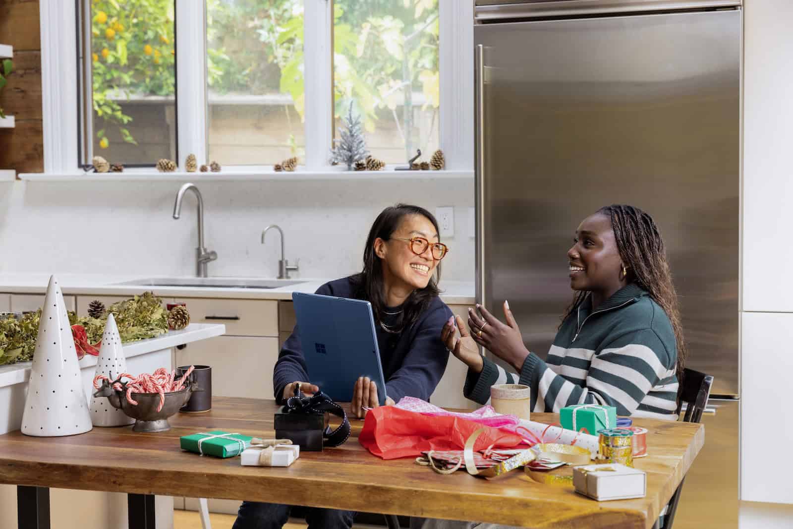 Everyday business owners managing online orders and payments from a laptop